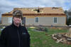 Patricia Brown stands in front of what's left of her house, at 6035 Janeway Rd., after a storm ravaged the area late Wednesday, March 23, 2011. Her husband, who was at work at the airport when storm hit, built the house himself.