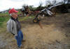 Bobby Anderson surveys the damage to structures on his farm caused by a storm that passed through the area Wednesday night in Greenback, Tenn., Thursday, March 24, 2011.