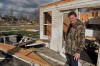 David Cooper surveys the ruins of his three-story home in Blount County on Thursday morning after a tornado ripped through the area the night before. Neither Cooper nor any of his family members were in the house when the storm hit. 'If we had been here, there would have been no escape,' Cooper said.
